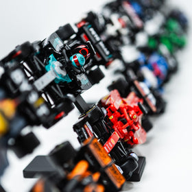 Brickify Speed Champions F1 stand with friction-fit clips securing two cars per level.