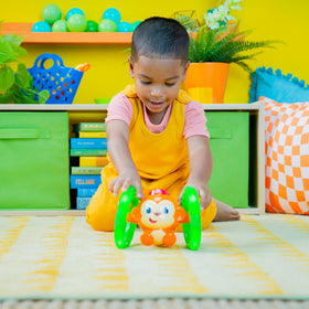 Bright Starts Roll & Glow Monkey catch-and-repeat play enhances interaction.