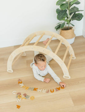 Brooklyn Neutral child using fridge magnets for hands-on spelling practice