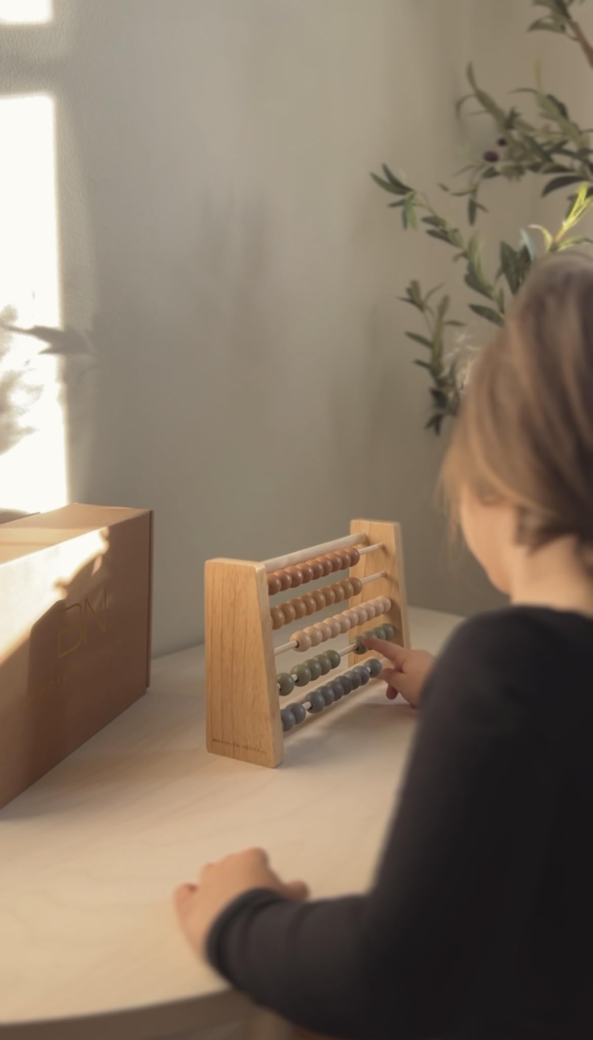 Brooklyn Neutral educational decor meets hands-on counting for early math exploration.