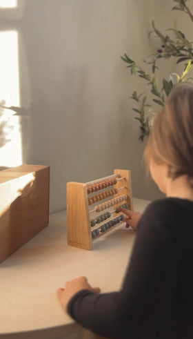 Brooklyn Neutral educational decor meets hands-on counting for early math exploration.