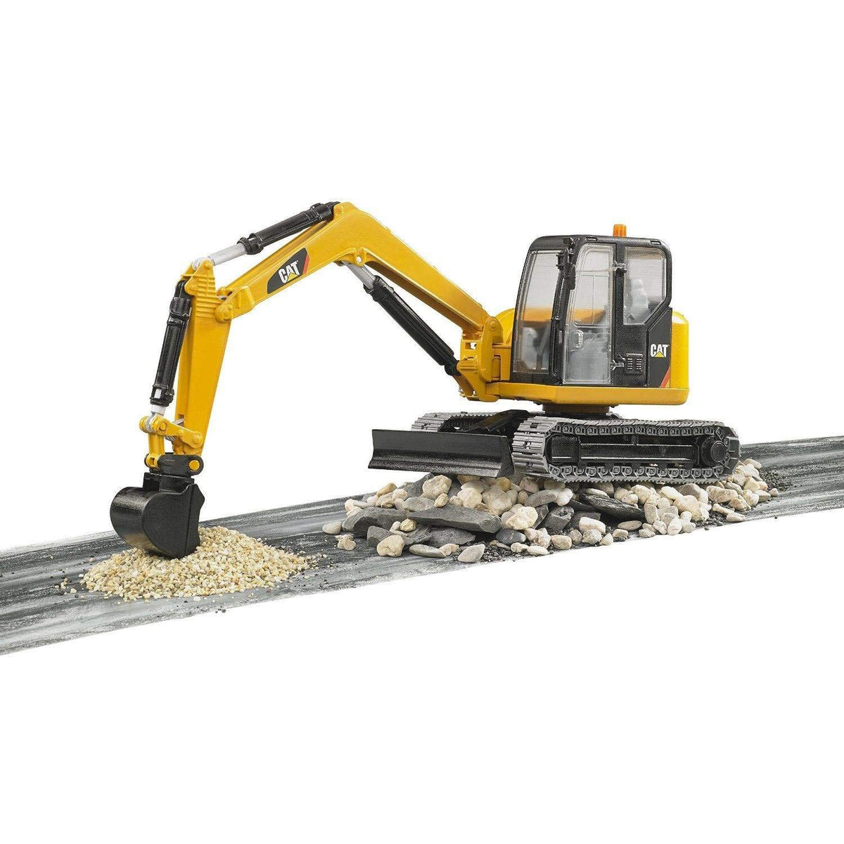Bruder 02457 CAT mini excavator front-blade leveling for stable ground play.
