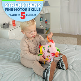 Buckle Toys Boink Pig with colorful straps encourages hands-on exploration.