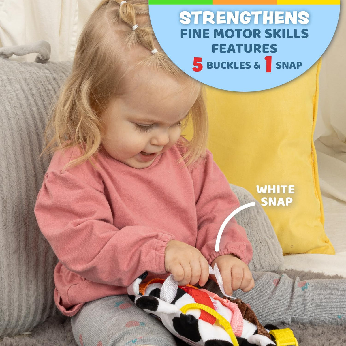 Buckle Toys Bessie Cow features a snap to practice grip and sequencing.