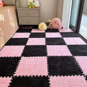 BXEBUI pink and black puzzle mats interlock for a soft play area.
