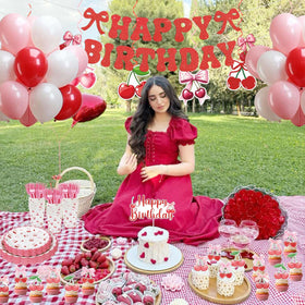 Caisehabu cherry tablecloth and banner create a charming party backdrop.
