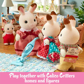 Calico Critters laundry set placed in a cozy dollhouse scene for imaginative chores
