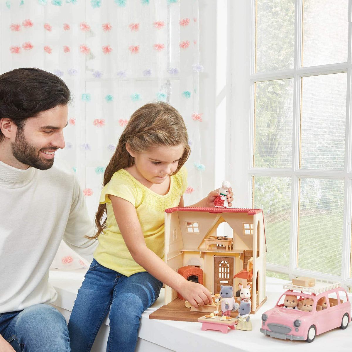 Calico Critters pink van tires and steering wheel for realistic pretend driving.