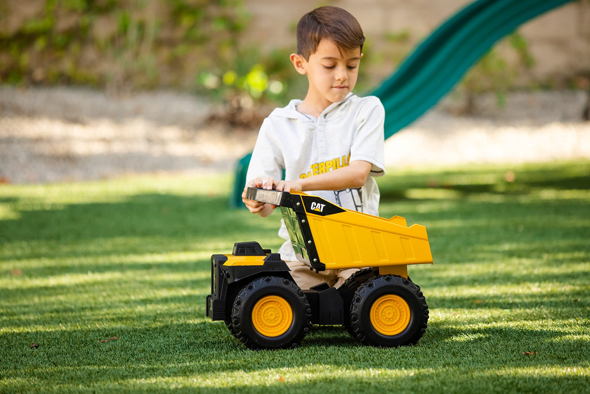 CAT Mighty Steel Dump Truck 20-inch yellow finish stands out on any play surface.