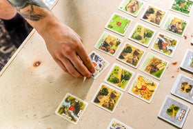 CATAN Rivals hero tokens boost settlements and cities.