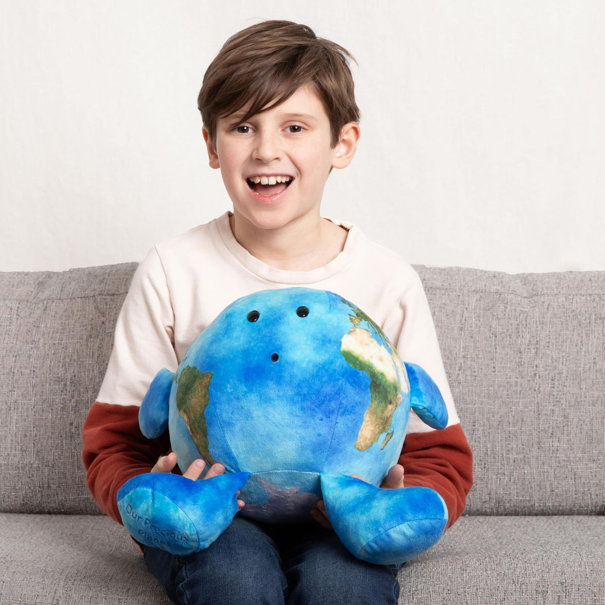 Large 16-inch Celestial Buddies plush displayed on a chair for easy handling.