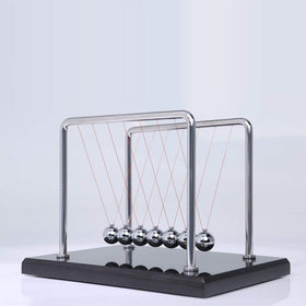 CERROPI Newton cradle in action demonstrating pendulum motion on desk