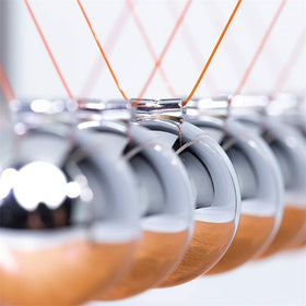 CERROPI Newtons Cradle on a tidy desk setup for focus.