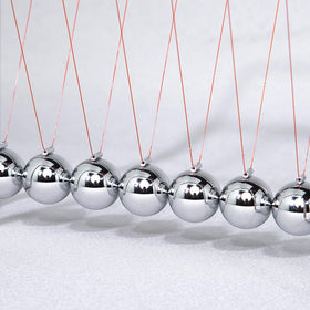CERROPI Newtons Cradle on a tidy desk setup illustrating office decor