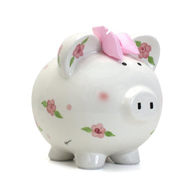 Child to Cherish piggy bank front view shows vibrant posies and dots encouraging saving
