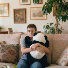 Chilsoby panda cuddled on lap demonstrates soothing sensory hug