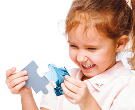 Children playing with a Clementoni Cars On The Road puzzle in a cozy room