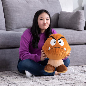 Club Mocchi Mocchi Goomba plush serves as a fun cuddle pillow for lounging.
