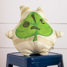 Korok plush styled on a shelf as a decorative pop of color.