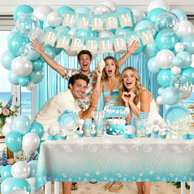 Cocomigo blue fringe curtains frame the party backdrop with color.