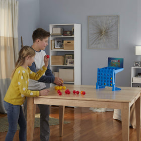 Connect 4 Shots two players competing in a lively indoor duel.