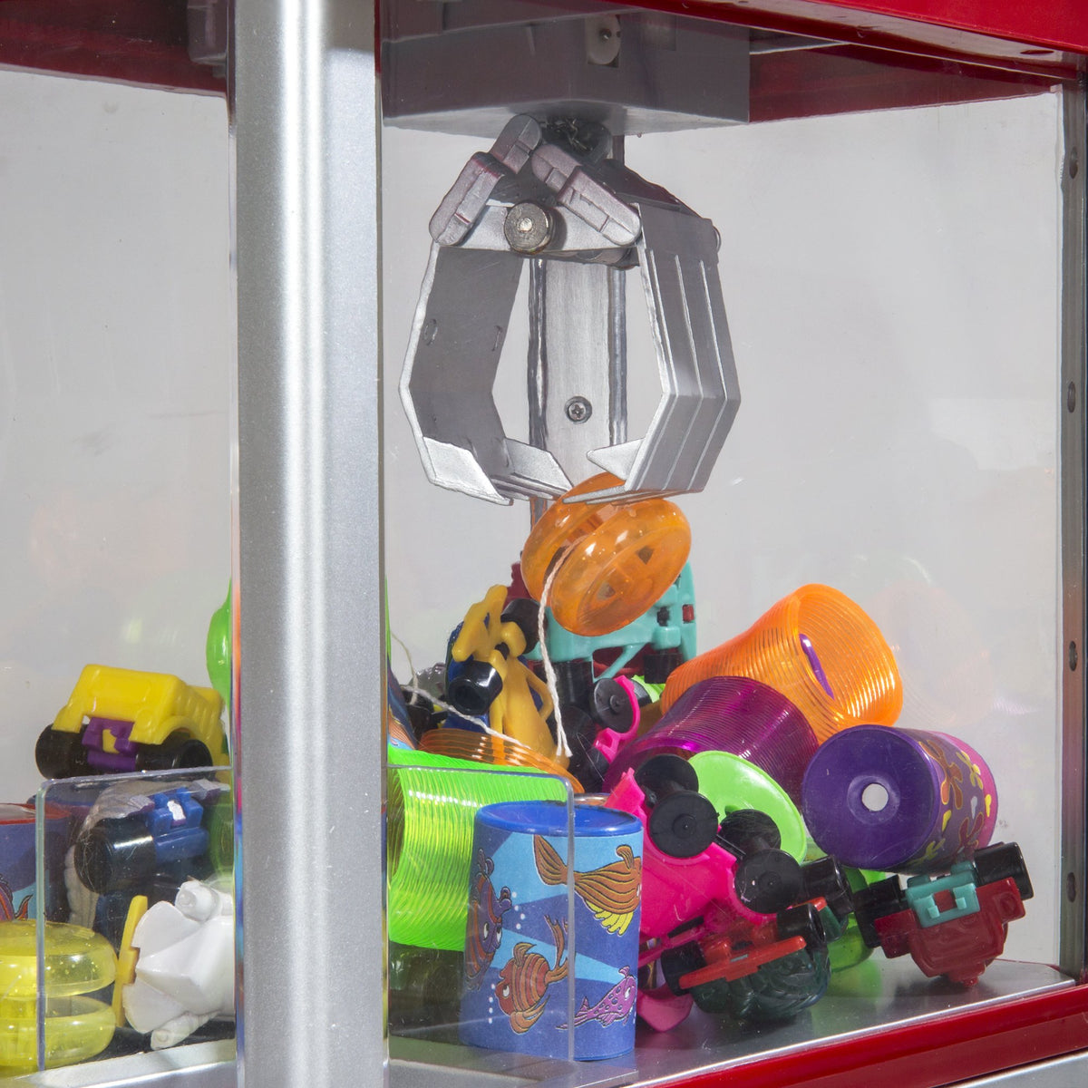 Constructive Playthings Carnival Crane controls illustrate precise joystick motions for grabbing prizes