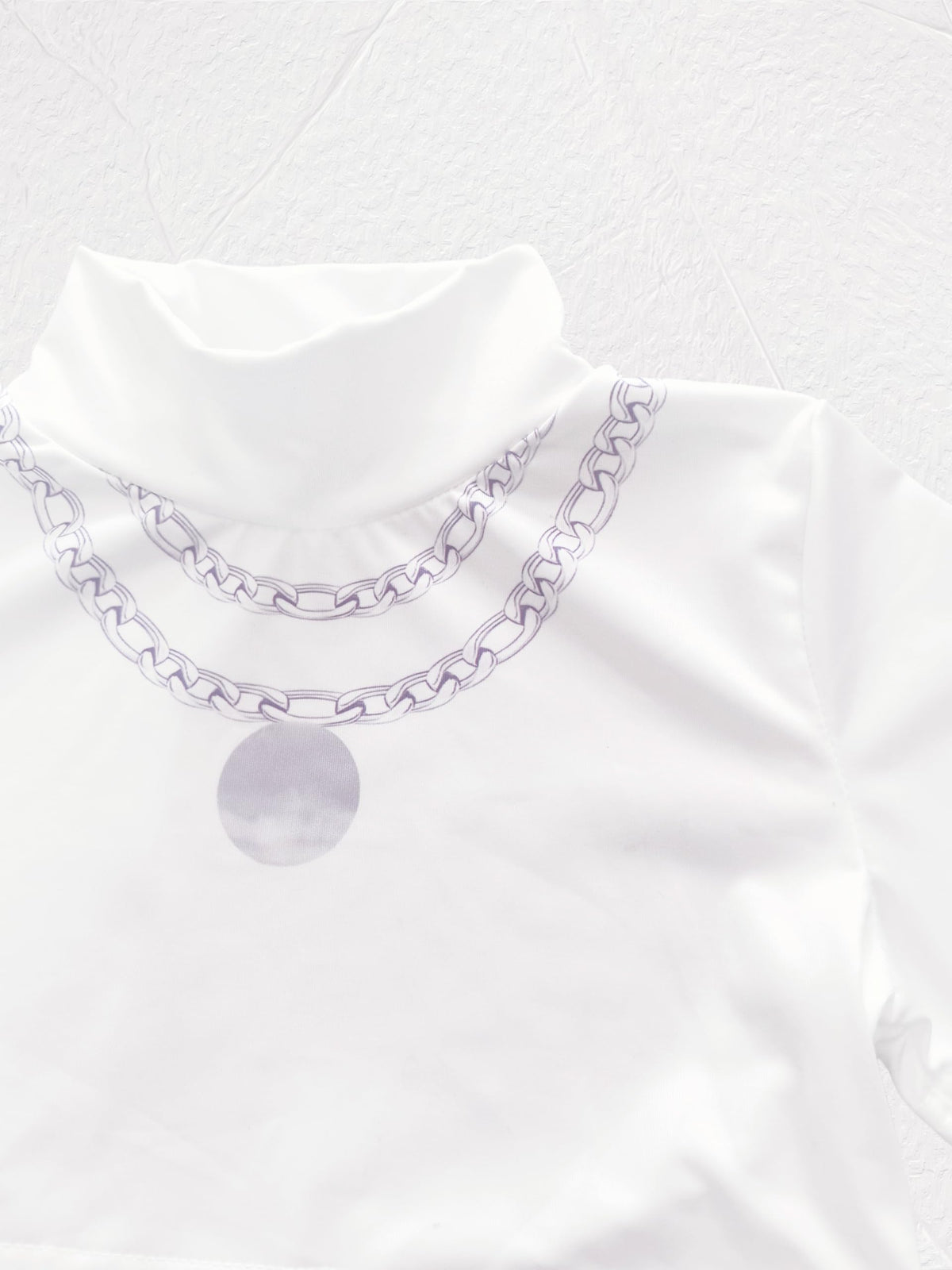 Coolproud Rumi mock-neck top shows layered necklace print