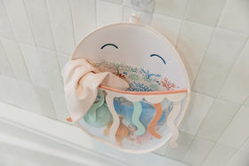 Copper Pearl Oceana decorative bath toy holder featuring Finn, Cora, and Wade.