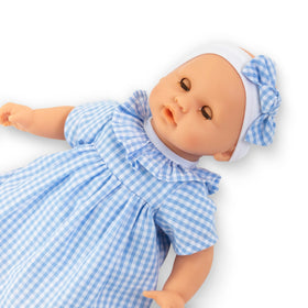 Corolle Premier Poupon Calin matching cap completes cozy outfit.