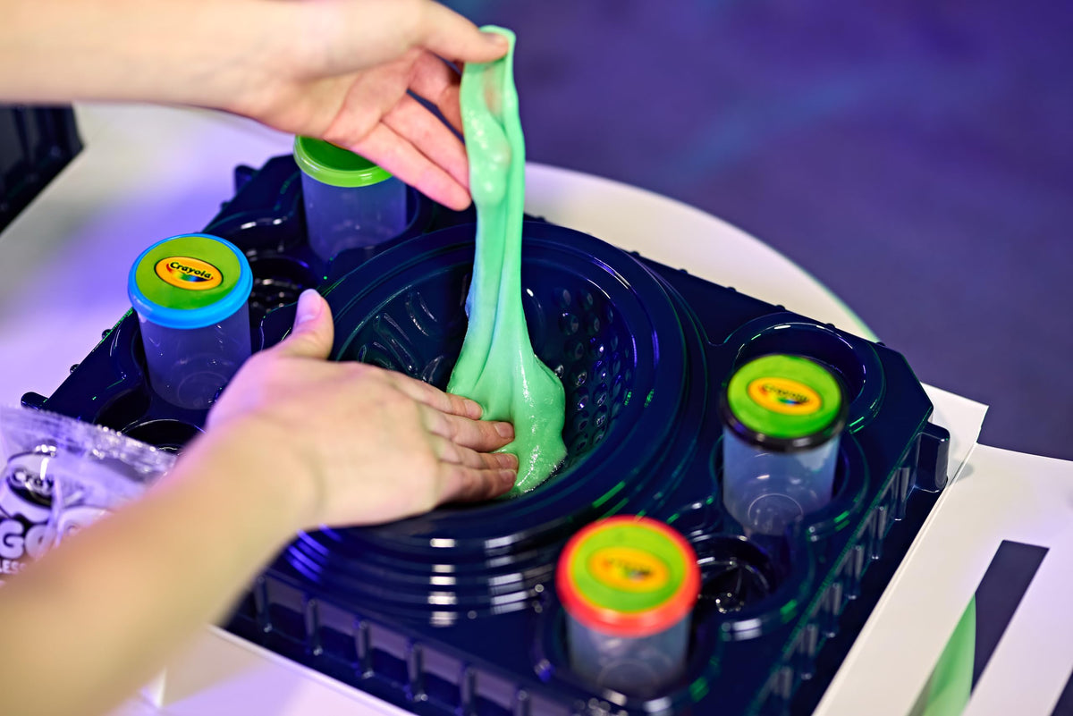 Crayola Galactic Goo mixing setup with powders and mix-ins for colorful experiments.