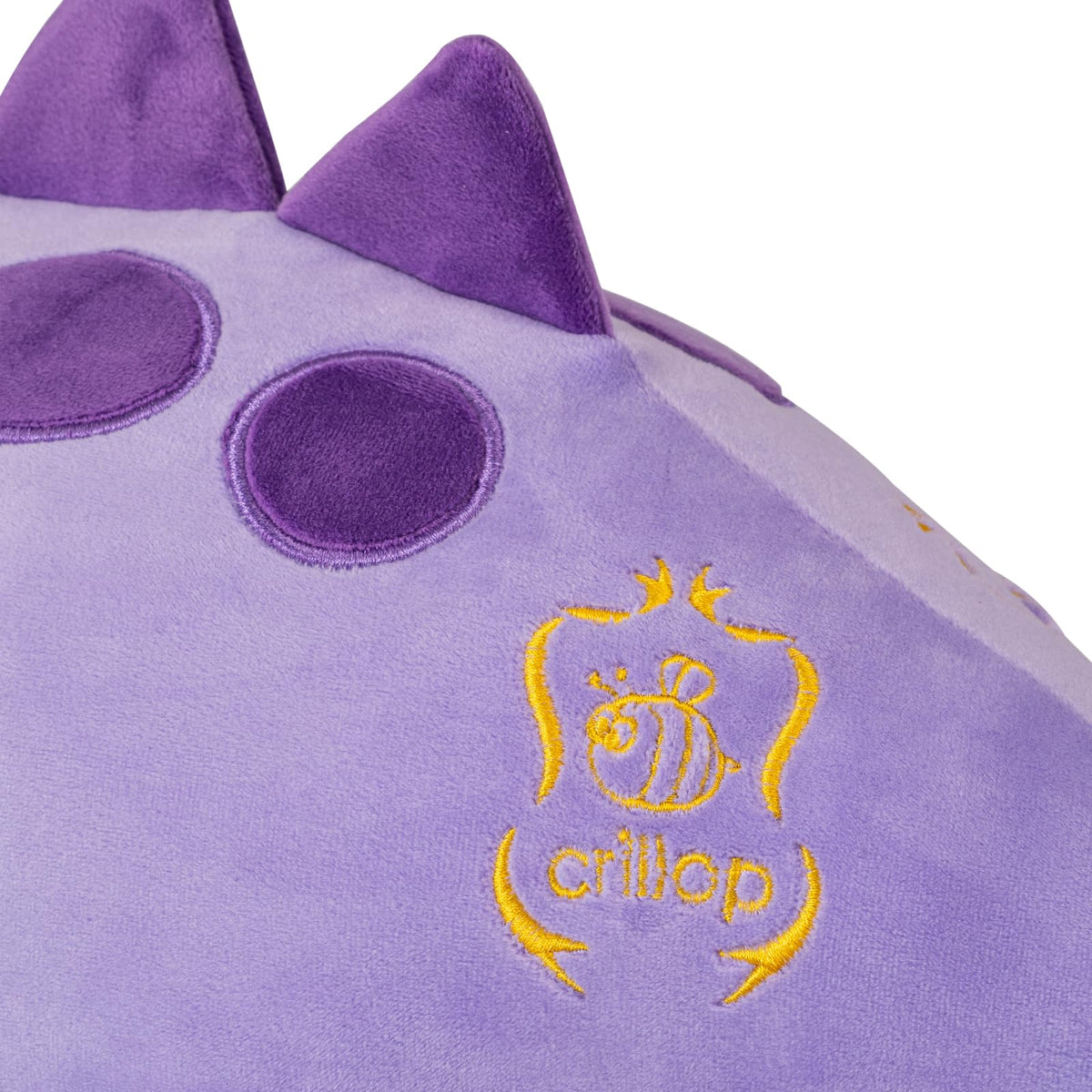 Crillop dinosaur plush with green-brown spots highlights unique, kid-friendly design.