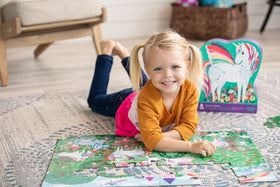 Crocodile Creek Unicorn Dreams floor puzzle in kids' hands showing easy-to-handle pieces