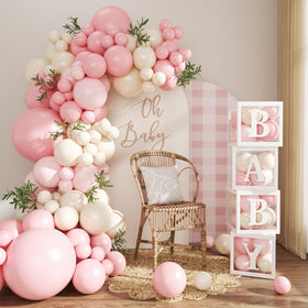 CROSSFINGERS Pink Balloon Arch Kit, assembled, creates a soft pastel backdrop for baby showers.