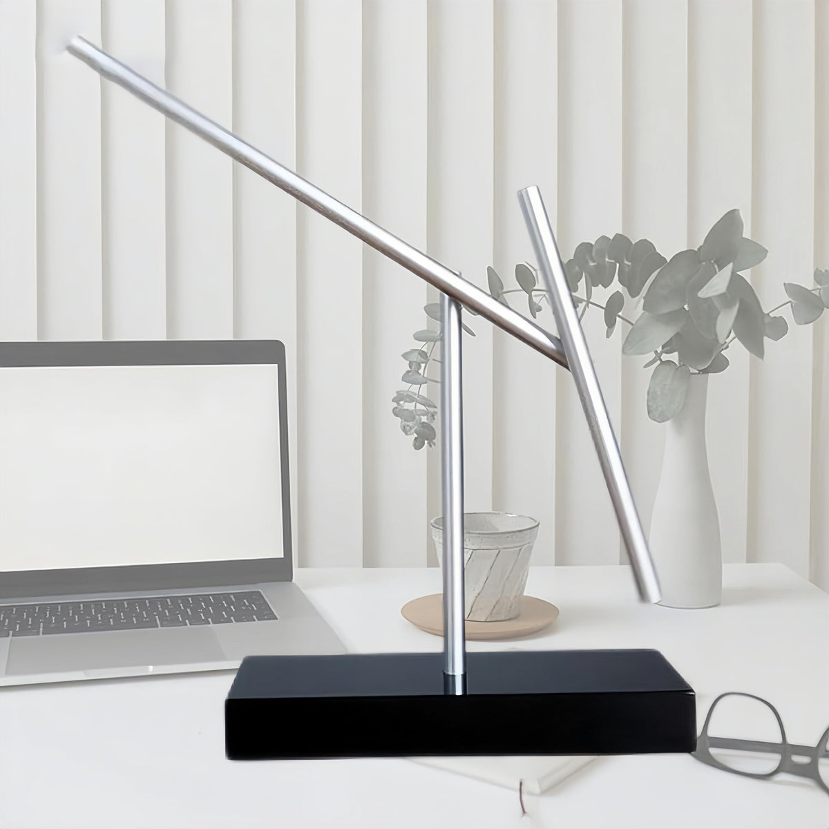 CulinaryEdge kinetic energy sculpture illuminated, highlighting dynamic movement and modern lighting appeal.