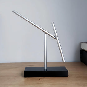 CulinaryEdge kinetic energy sculpture motion closeup, capturing rotating pendulum and smooth transitions.