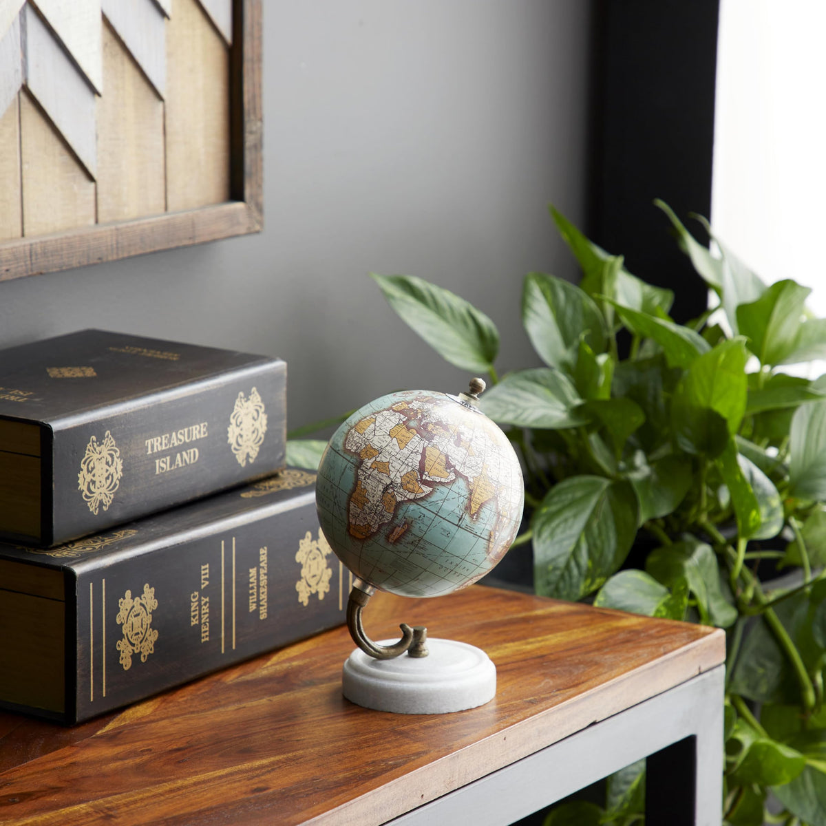 White marble base provides a refined foundation for the globe.