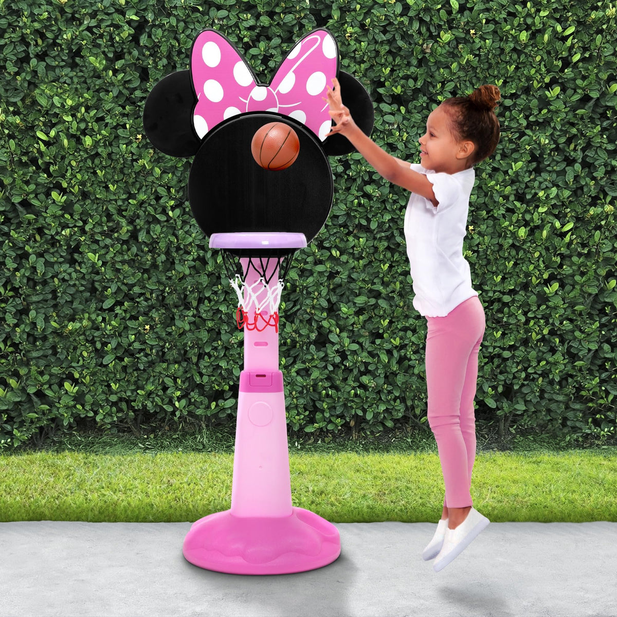 Delta Children Minnie Mouse height-adjustable hoop shown in action for growing players.