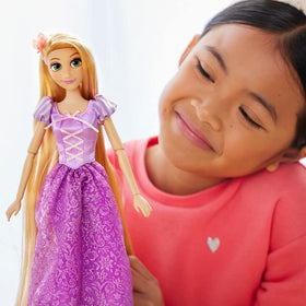 Disney Store Rapunzel rooted hair with fabric flower for lifelike styling.