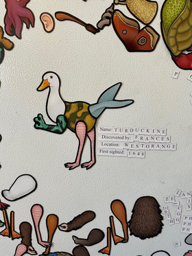 Dissent Pins Cryptid Kit on a fridge shows quick, creative play sessions