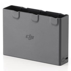 DJI Avata 2 Two-Way Charging Hub on desk powering three batteries