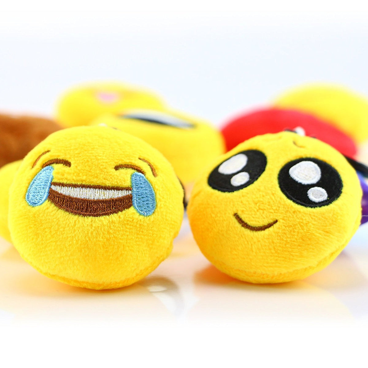 Dreampark emoticon plush close-up shows soft texture and friendly faces.