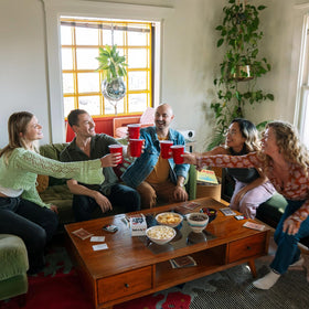 DSS Games Take A Sip If… dinner party setup with drinks and laughter
