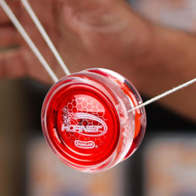 Duncan Hornet Pro looping yo-yo translucent color red cap shot emphasizes vibrant design.