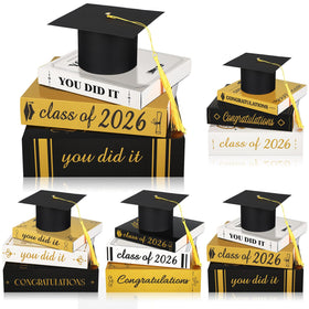 Dunzoom Class of 2026 cap and books set on desk for stylish graduation decor.