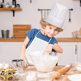 Ecoofor kids wearing set while baking illustrates versatile home learning.