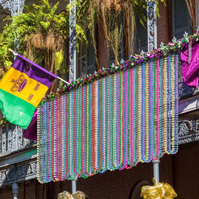 Elefama Mardi Gras beads parade throws for festive atmosphere.