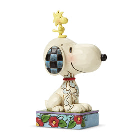Enesco Jim Shore Peanuts figurine, hand-painted stone resin, detailed floral motifs.