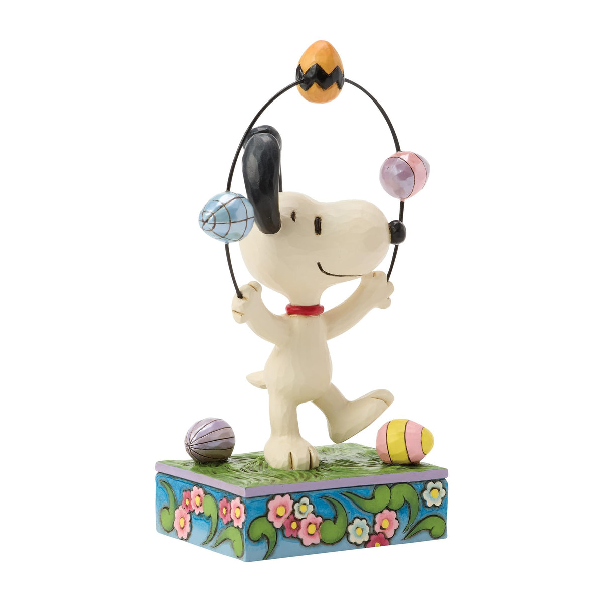 Enesco Snoopy on a floral grass base display for shelves.