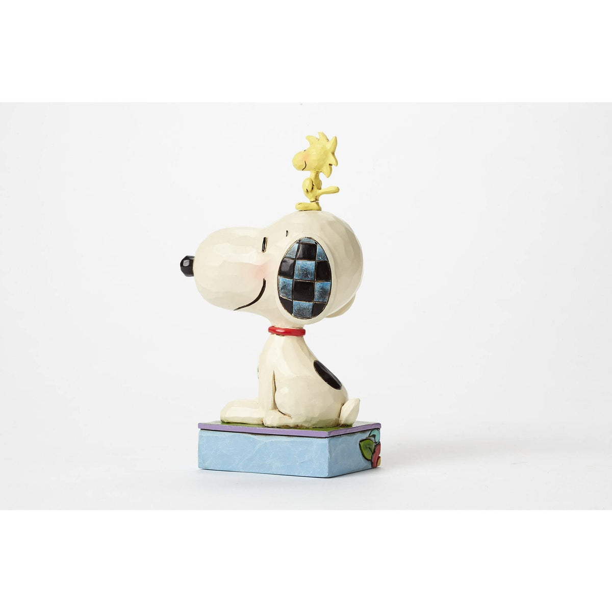 Snoopy and Woodstock figurine close-up shows intricate folk-art patterns.