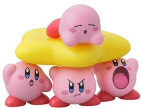 Warp Star centerpiece with stacking Kirbys enhances shelf display and collection.